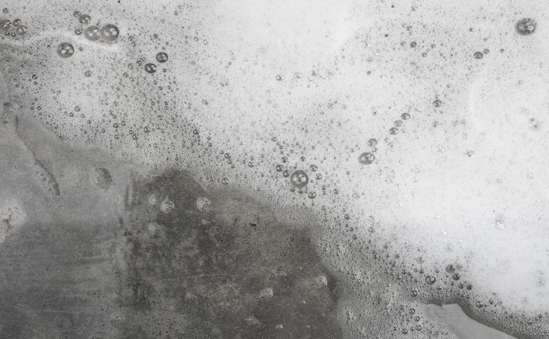 Apply concrete degreaser to oil stain
