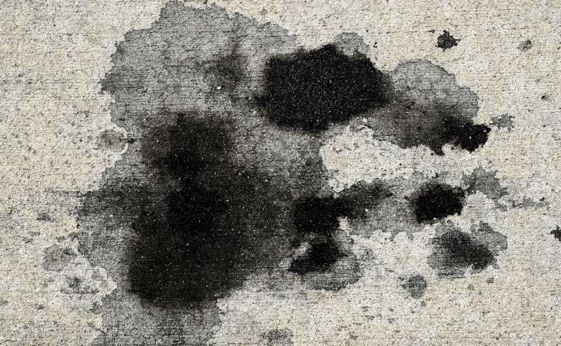 Oil stain on concrete driveway floor