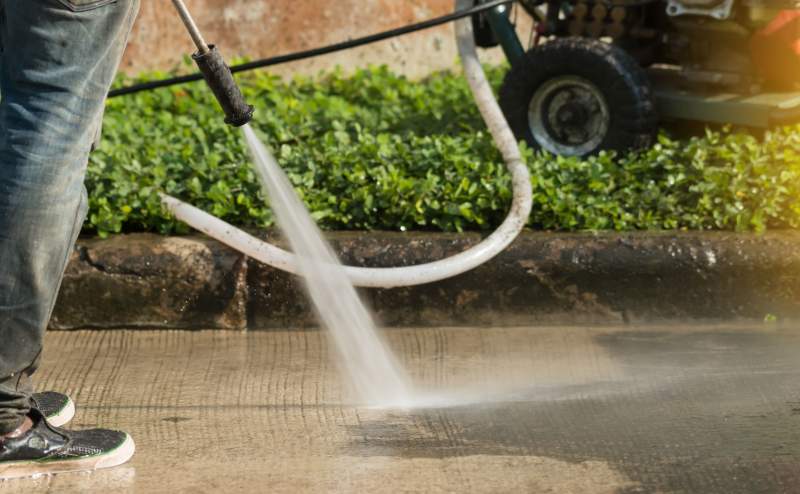 Power washer removing tire marks from concrete 