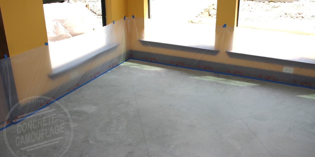 using tape and plastic to protect walls when staining concrete