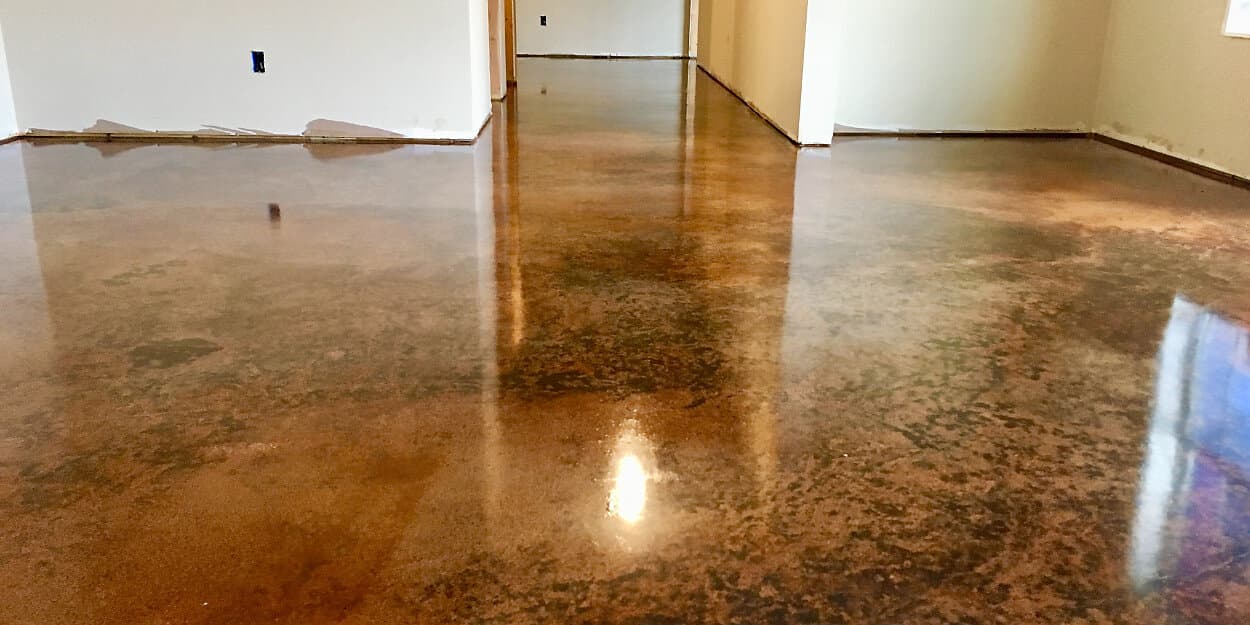 Beautiful exterior stained concrete driveway with woman showing it off